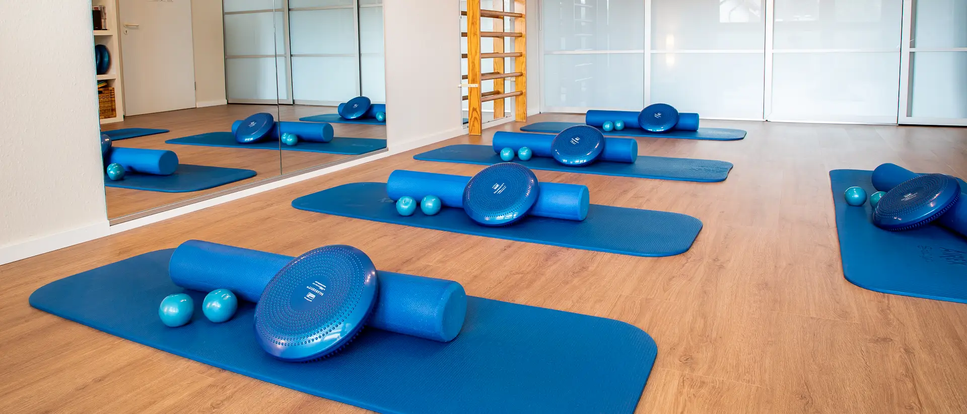 Raum mit Matten und Pilates-Equipment für Gruppentraining